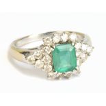 An 18ct white gold diamond and green stone dress ring, size R 1/2, approx 6.2g.Additional