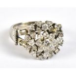 An 18ct white gold cluster ring set with approximately thirty three brilliant cut stones, the