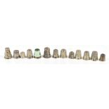 A group of twelve white metal thimbles including two with wirework decoration and an enamelled