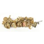 A good 9ct yellow gold charm bracelet supporting a wide range of charms including an elephant, a
