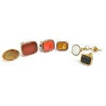 A group of six 19th century yellow and white metal fobs including large carnelian example engraved