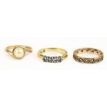 An 18ct yellow gold four stone ring, size L, approx 4g, a 9ct yellow gold eternity ring, size N 1/2,