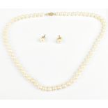 A strand of cultured pearls with yellow metal clasp stamped 14k, overall length 45cm, and a matching