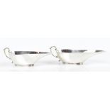 HENRY MATTHEWS; a pair of Edwardian and silver sauce boats of small proportions, Birmingham 1908,