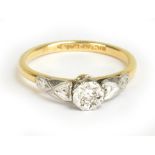 An 18ct yellow gold and platinum tipped diamond solitaire ring, the tiny diamond weighing approx 0.