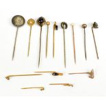 A group of fourteen assorted stick pins including Masonic examples, one with a Victorian coin, one
