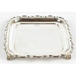 WALKER & HALL; a George V hallmarked silver salver of square form with cast scalloped edge,