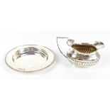 HORACE WOODWARD & CO LTD; an Edward VII hallmarked silver dish of circular form with cast beaded