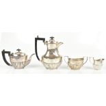 GF WESTWOOD & SONS; a George V hallmarked silver three piece tea service with gadrooned lower