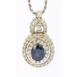 An 18ct white gold chain supporting a sapphire and diamond pendant, the oval sapphire approx 1.