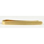 A 14ct yellow gold tie clip with engine turned decoration, length 4.5cm, approx 6.6g.Additional