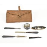 A six piece silver backed and steel bladed manicure set contained within a suede roll, hallmarks