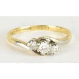 An 18ct yellow gold platinum set three stone diamond ring, the central stone weighing approx 0.