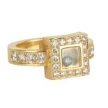 CHOPARD; a lady's 18ct yellow gold and diamond 'Happy Diamond' ring featuring single loose stone