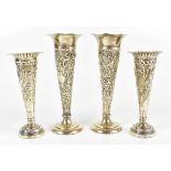 WILLIAM COMYNS; a pair of late Victorian hallmarked silver loaded bud vases with embossed