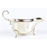 ADIE BROS LTD; a George V hallmarked silver sauce boat raised on three hoof feet, Birmingham 1922,