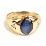 A 9ct yellow gold star sapphire and two stone diamond ring, size S 1/2, approx 5.9g.Additional