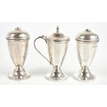 DENNISON, WIGLEY & CO; a George V hallmarked silver three piece cruet set of pedestal form,