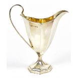 WILLIAM AITKEN; a Victorian hallmarked silver cream jug of panelled form with gilt interior, Chester