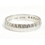 BOODLES; a platinum wedding band with chevron detailing, size M 1/2, approx 2.7g.Additional