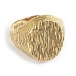 A 9ct yellow gold signet ring with textured decoration to the front, approx size N, approx 6.9g.