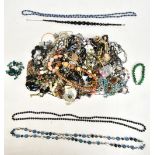 A mixed group of costume jewellery including bead necklaces, brooches, bangle, etc.
