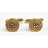 DEAKIN & FRANCIS; a pair of 9ct yellow gold target cufflinks, the centre set with a cabochon