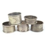 A George V hallmarked silver napkin ring, Chester 1921 and four other hallmarked silver napkin