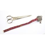 A pair of late 19th century white metal handled sewing scissors with sheath, length 11cm, and a