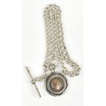 A silver graduated Albert chain with fob set with a figure playing table skittles, length 41cm.