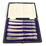 CH BEATSON; a cased set of six George V hallmarked silver handled fruit knives, decorated in the