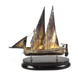 A late 20th/early 21st century Maltese silver model of a boat with twin sails and rudder and foliate
