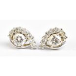 A pair of 18ct white gold diamond cluster ear studs, each set with an approx 0.33cts central