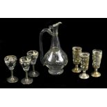 A clear glass and silvered foliate motif ewer and matching set of three glasses, height of ewer 17.
