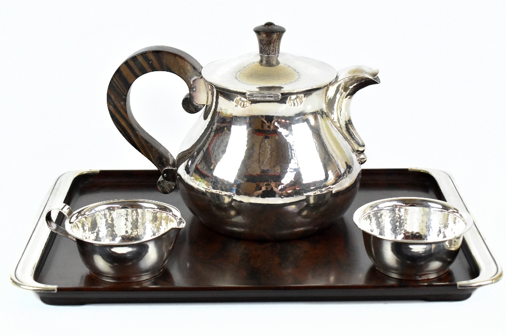 A German 835 grade silver three piece tea service, comprising teapot with rosewood handle and