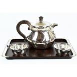A German 835 grade silver three piece tea service, comprising teapot with rosewood handle and