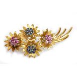 An 18ct yellow gold ruby and sapphire floral spray brooch, length 5.2cm, approx 11.2g.Additional