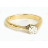 An 18ct yellow gold, platinum tipped diamond solitaire ring, the round brilliant cut diamond