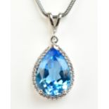 A 9ct white gold chain supporting a white gold pear shaped blue spinel and diamond set pendant,