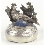 An Edward VII imported hallmarked silver pin cushion, raised on circular base with pheasant and