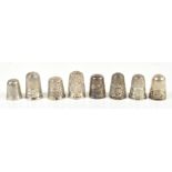 HENRY GRIFFITH & SONS LTD; a group of eight hallmarked silver thimbles including an Elizabeth II