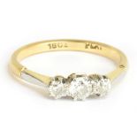 An 18ct yellow gold platinum tipped three stone diamond ring, the central stone weighing approx 0.