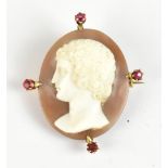 An unusual Victorian cameo brooch in yellow metal frame set with four small rubies and in fitted