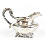 JAMES MOORE & EDWARD MURRAY; a Victorian hallmarked silver cream jug of squat form with a cast