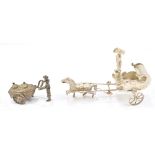 A white metal miniature depicting gentleman stood on cart modelled as grotesque dolphins pulled by