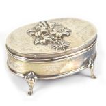 W & M DODGE; an Edwardian hallmarked silver oval trinket box with floral embossed decoration to