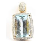 A large 18ct yellow gold aquamarine and diamond pendant, the aquamarine measuring 18 x 12.9 x 9.