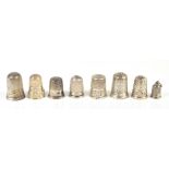 CHARLES HORNER; a group of eight hallmarked silver thimbles including a miniature thimble charm