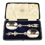 EDWARD PAYNE; a cased pair of presentation spoons with figural and pierced terminals and oval bowls,