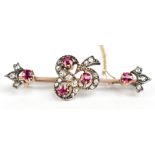 An Edwardian yellow metal diamond and possibly pink spinel brooch with pierced framework, length 4.